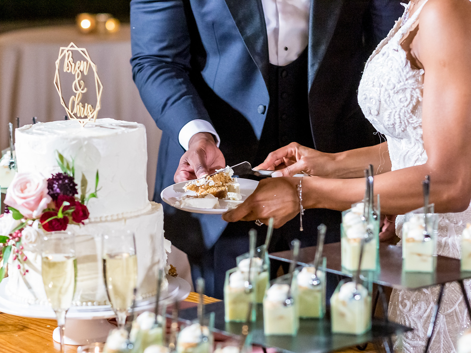 Events - Bride and the groom cutting the beautiful white wedding cake