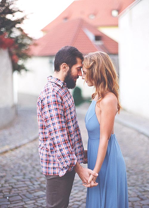 wedding-photographer-fiance-couple Montreal engagement photography — couple walking hand in hand in a sunlit Old Montreal laneway